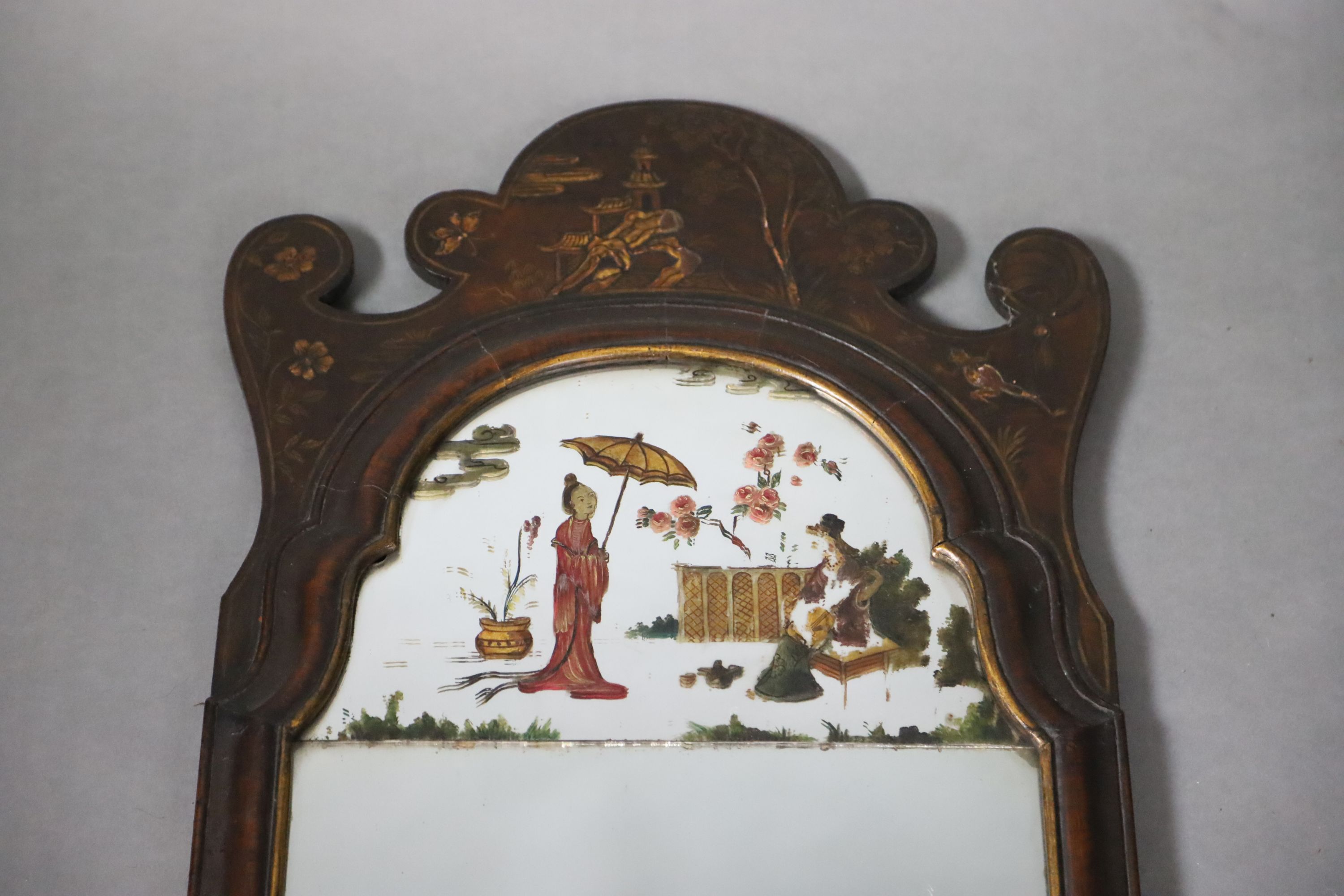 An early 18th century style chinoiserie lacquered walnut wall mirror, W.38cm H.119.5cm